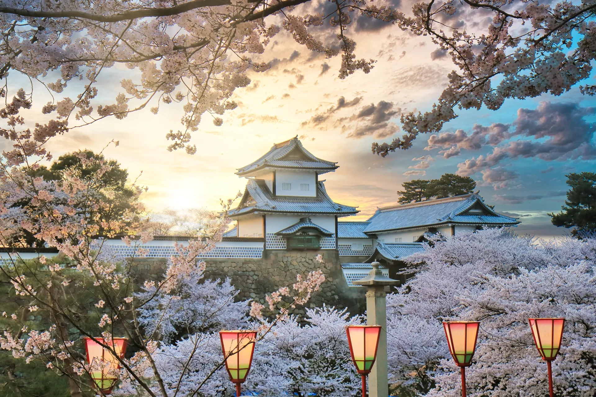 Kanazawa Castle surrounded by blooming pink cherry blossom trees in spring - one of the best time to visit Japan